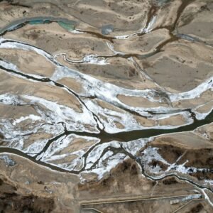an aerial view of a river and land