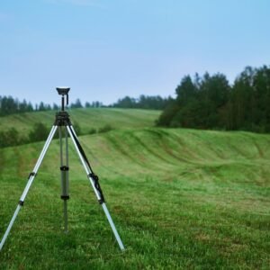 black and white tripod on green grass field during daytime